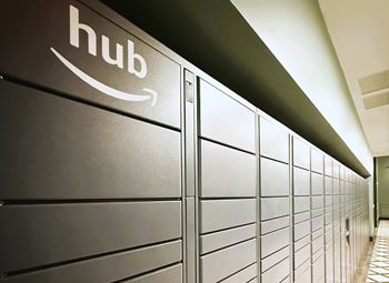 A row of Amazon hub lockers are lined up in a hallway. at LiveWell Apartments, Pittsburgh
